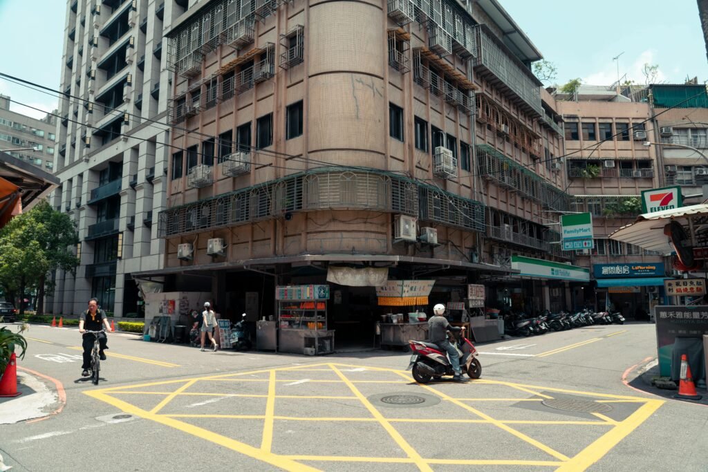 A bustling street corner in New Taipei City, featuring local shops and lively urban life.