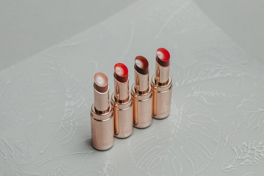 A stylish set of lipsticks arranged on a decorative textured surface, perfect for fashion and beauty themes.
