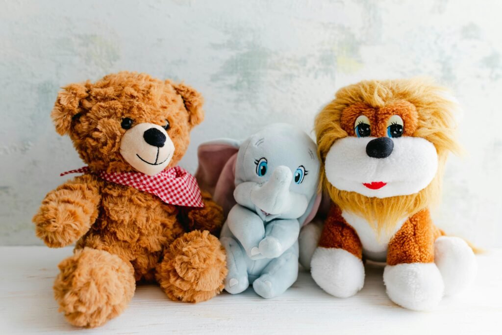 Adorable plush toys featuring a teddy bear, lion, and elephant perfect for children's gifts or decor.
