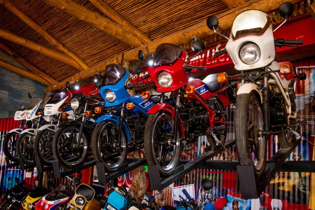 A collection of classic motorcycles showcased in a rustic indoor garage setting.